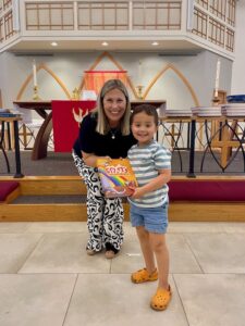 Pastor presenting bible to child