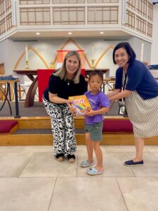 Pastor presenting bible to child