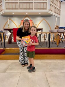 Pastor presenting bible to child