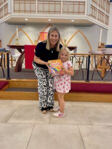 Pastor presenting bible to child