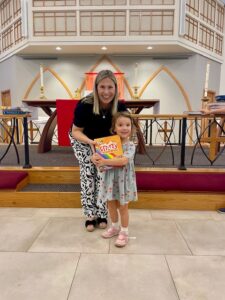 Pastor presenting bible to child