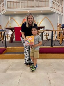 Pastor presenting bible to child
