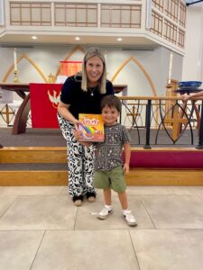 Pastor presenting bible to child